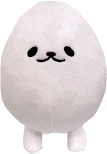 a stuffed animal in the shape of an egg with black eyes and a mustache