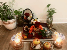 a display of fruits and flowers with a mirror on top