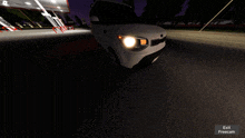 a white car is driving down a road with the words exit freecam visible