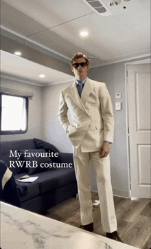 a man in a suit is standing in a room with the words my favourite rwrb costume