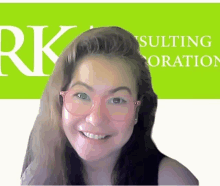 a woman wearing pink glasses is smiling in front of a green rk consulting logo