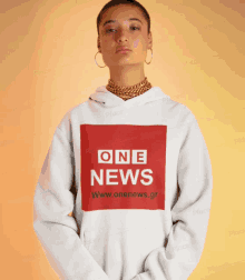 a woman wearing a hoodie that says one news on it