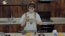 a woman in an apron is preparing food in a kitchen with a carton of milk in front of her