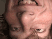 a close up of a person 's face with their mouth open and teeth visible