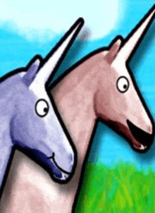 two unicorns are standing next to each other in the grass .