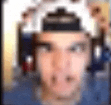 a blurry picture of a man wearing headphones and a baseball cap .