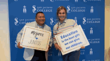 a man and a woman holding up signs that say mejores juntos and education is the best gift we can give our children