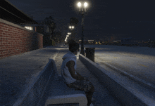 a person is sitting on a bench in a video game