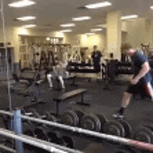 a man is jumping in the air in a gym .