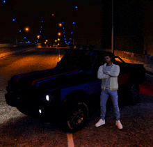 a man stands in front of a truck that has all terrain tires on it