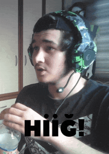 a man wearing headphones has the word hiig written on his shirt