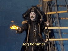 a man in a pirate costume is holding a torch and the words jeg kommer are above him