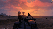 a couple sits on the back of a truck looking at the sunset in a game