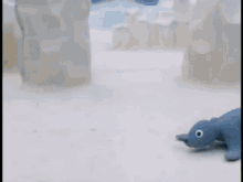 a seal is crawling on the ground in front of icebergs in a cartoon .