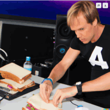 a man in a black shirt with the letter a on it