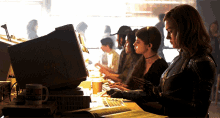 a woman sits at a desk in front of a computer with a mug on it that says ' avengers ' on it