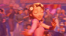 rapunzel from tangled is dancing in front of a crowd of people with a flower in her hair .