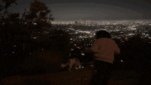 a person standing on a hill with a city in the background and the word shagarita on the bottom right