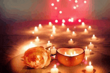 a heart shaped candle holder and a rose are on a table with candles .