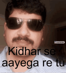 a man wearing sunglasses with the words kidhar se aayega re tu