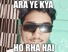 a man wearing sunglasses with the caption ara ye kya ho rha hai on his face