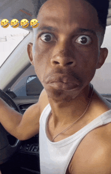 a man making a funny face while driving a car