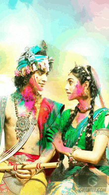 a painting of a man and a woman with holi paint on their face