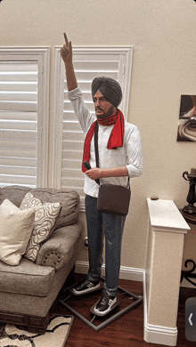 a statue of a man in a turban and scarf is standing in a living room