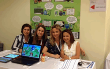 a group of women sitting at a table with a laptop in front of a sign that says ' matematik lab '