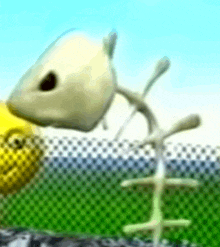 a skeleton of a fish with a yellow face is eating a piece of food .