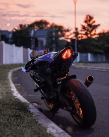 a blue motorcycle is parked on the side of the road