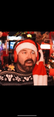 a man wearing headphones and a santa hat