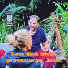 a man and a woman are sitting in the jungle and the words lassen dich nicht provokieren jetzt