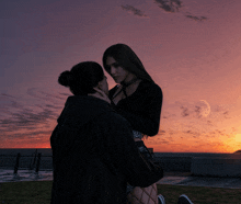 a man and a woman are kissing in front of a full moon