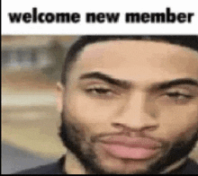 a man with a beard is making a funny face with the words `` welcome new member '' written above him .