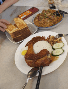 two plates of food on a table with a phone on the table