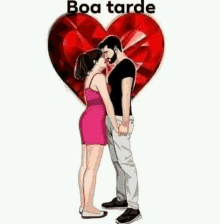 a man and woman are kissing in front of a red heart .