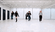 a group of women are dancing in a dance studio .