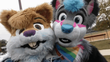 two furry mascots are posing for a picture