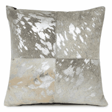 a pillow with a cowhide pattern is sitting on a white background