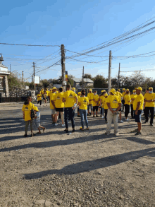 a large group of people wearing yellow shirts with the word pnc on them