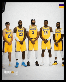 a group of lakers players pose for a picture