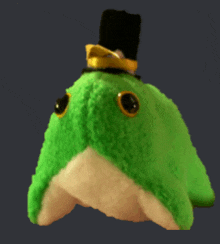 a green stuffed animal with a black top hat on it