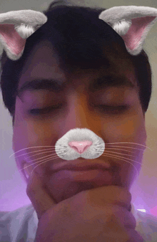 a man with his eyes closed has a cat ear filter on his face