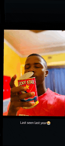 a man in a red shirt is opening a can of lucky star soup