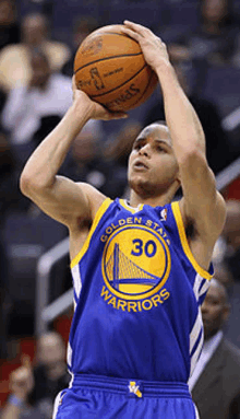 golden state warriors player stephen curry is about to shoot the basketball