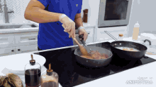 a man in a blue shirt is stirring food in a frying pan with a wooden spoon made in animatica