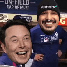 a man wearing a hat that says multivers is smiling next to another man