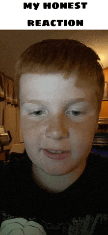 a young boy with red hair and freckles looks at the camera with the words my honest reaction above him