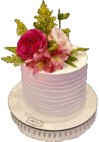 a white cake with pink flowers on top of it is on a white plate that says ' petite mai ' on it